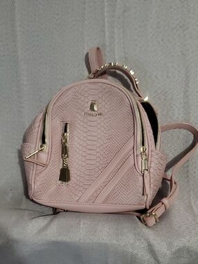 Tote & Carry Pink Textured Mini Backpack with Gold Accents